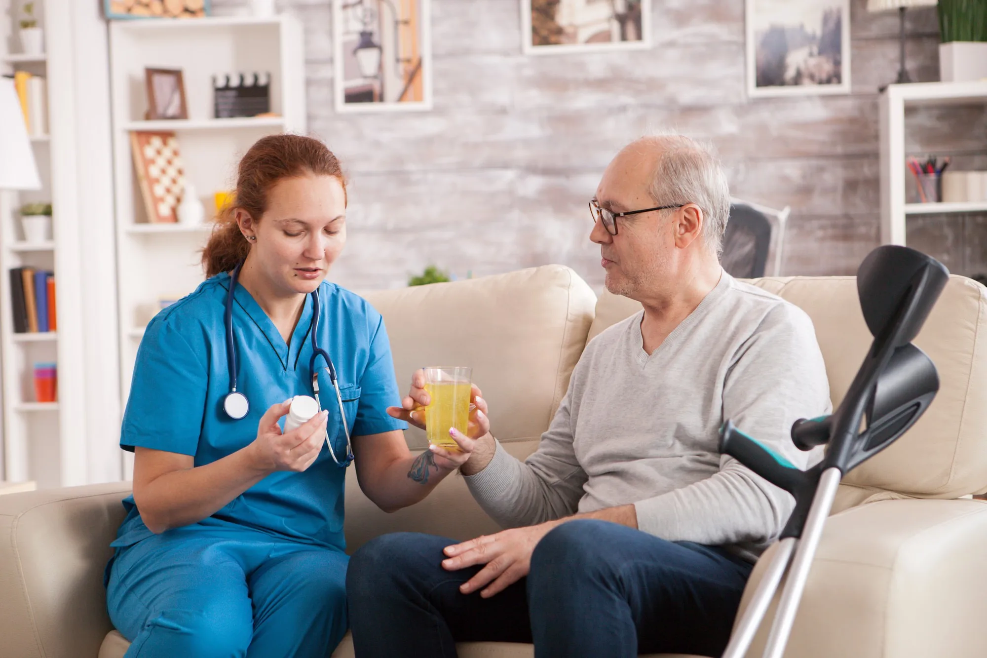 old-man-nursing-home-helped-by-female-doctor-take-
